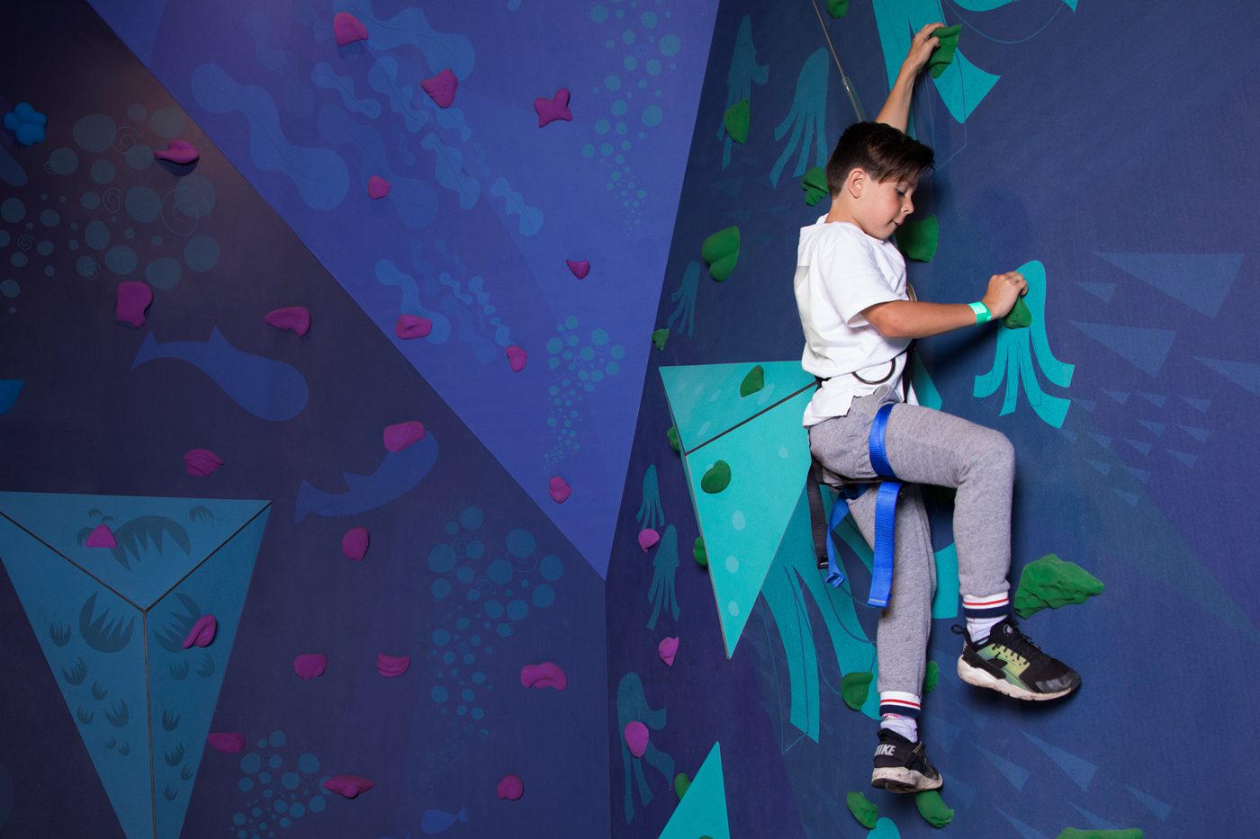 Rabbit Hole Play Centre Branding and Wayfinding by Principle Design_Boy rock climbing