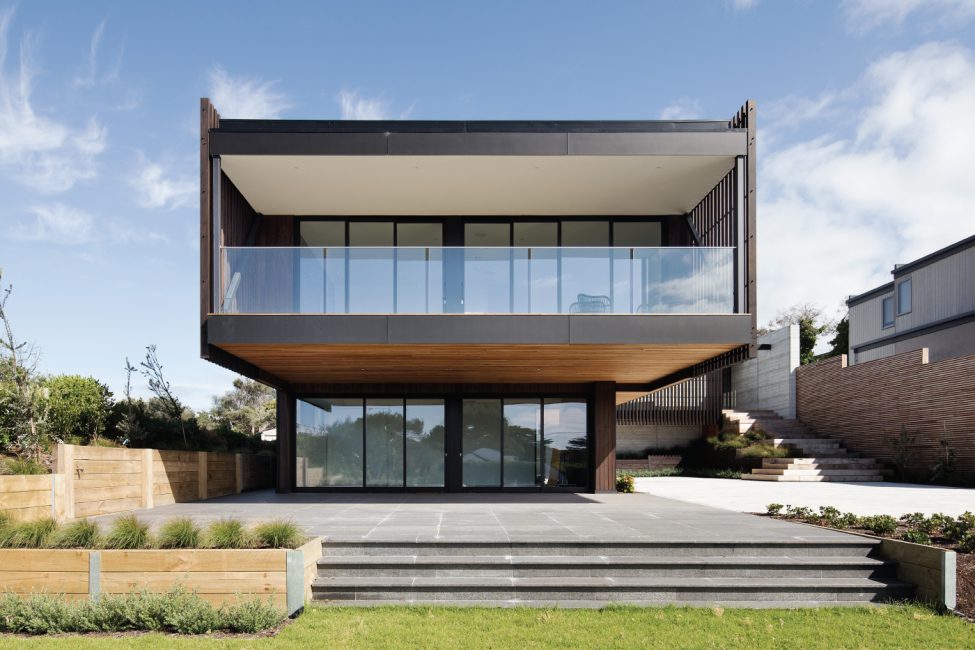 Modern double storeyed house with glass balcony panels