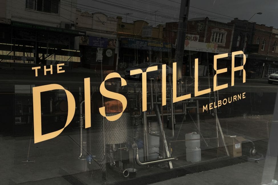 The Distiller logo on glass wall signage