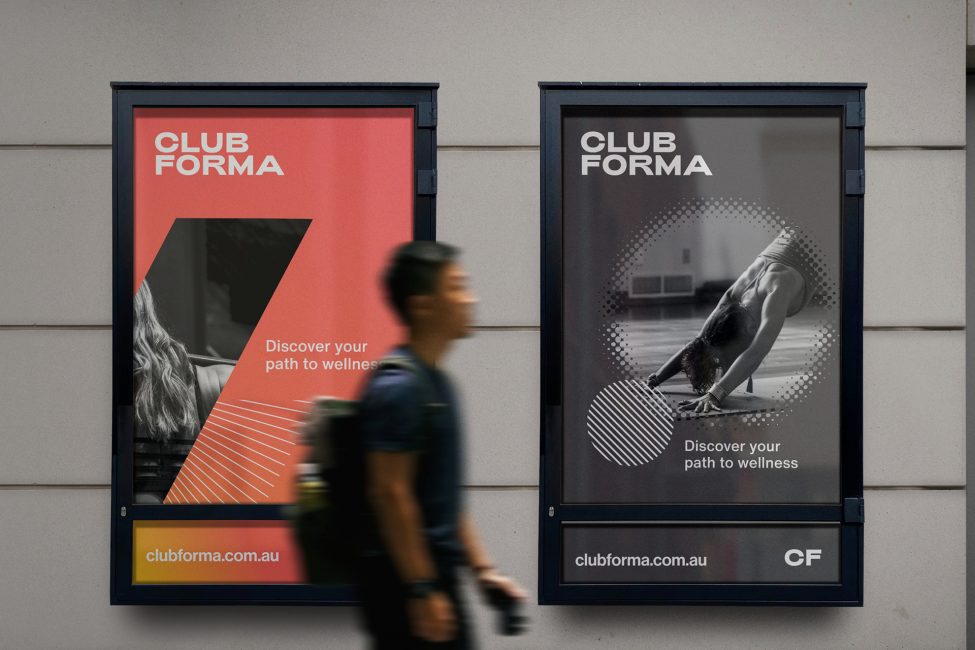 Club forma posters on the street with a pedestrian passing by